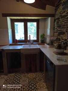 a kitchen with a sink and a window at CASA DA LOAIRA in Quiroga