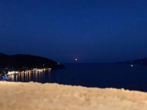 a view of a body of water at night at Fedra Apartments in Poros