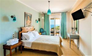 a bedroom with a bed and a desk and a television at Villa Letista in Parga