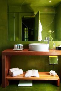 a bathroom with a counter with a sink and a mirror at Villa Cascais Boutique Hotel in Cascais