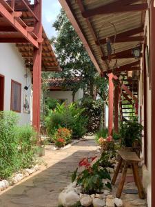a porch of a house with a wooden pergola at Pousada Flor de Debora in Alto Paraíso de Goiás