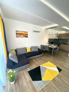 a living room with a couch and a table at Pegazus Apartman in Keszthely