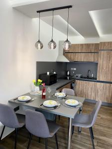 a dining room with a table and chairs at Pegazus Apartman in Keszthely
