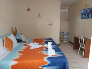 a dog is standing on a bed in a bedroom at Pousada Planeta Guarajuba in Guarajuba +99 photos