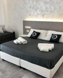 a bedroom with a large bed with towels on it at Sesto Senso Home in Santa Maria del Cedro