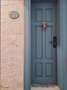 a door that is open to a room with a blue door at Casa Asti in Valletta