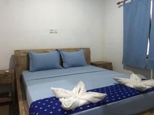 Postel nebo postele na pokoji v ubytování Turtle Island Homestay