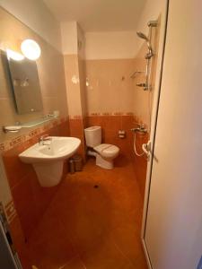 a bathroom with a toilet and a sink at Guest House Kostovi in Kiten +43 photos