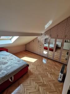 a small bedroom with a bed and a mirror at Stan na dan Bijeljina in Nova Mahala