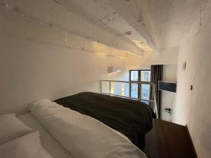a bedroom with a large white bed with a window at Lift Hotel Boutique - Derybasivska in Odesa