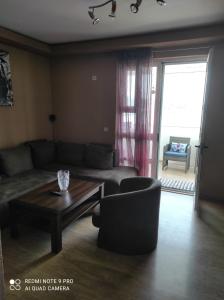 a living room with a couch and a coffee table at XXL Apartments in Dobra Voda