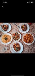 a group of plates of food on a table at Янтарная форель in Bushtyno