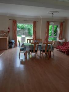 a dining room and living room with a table and chairs at Mount Wolseley Holiday Home - Privately Owned in Tullow