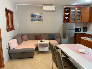 a living room with a couch and a table at Ana in Kostrena