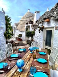 a wooden table topped with plates and bowls of food at Trulli e Puglia Resort in Alberobello