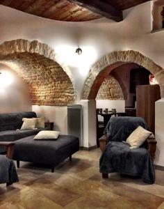 a living room filled with furniture and a large window at Trulli e Puglia Resort in Alberobello