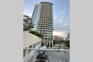 a tall building with a car parked in front of it at Quiet and cozy 2 BR apartment with stunning views in Dubai