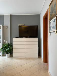 a living room with a television on a white dresser at Ana in Kostrena
