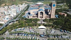 an aerial view of a city with a large building at Hotel dos Devotos in Aparecida