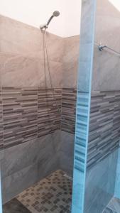 a shower with a glass door in a bathroom at apartment HOME in Bihać +17 photos