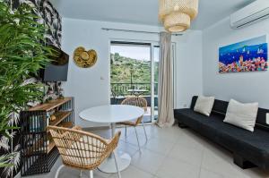 a living room with a couch and a table at Luxurious Apartments Maslina with Beach in Milna