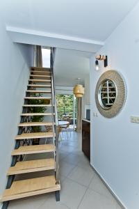 a staircase leading up to a room with wine bottles at Luxurious Apartments Maslina with Beach in Milna