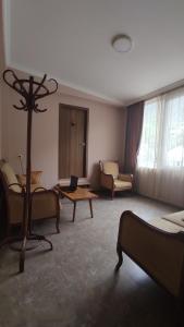 a living room with couches and a table with a laptop at Guesthouse Mabu - 4 Newly Built Rooms in the Heart of Mestia in Mestia