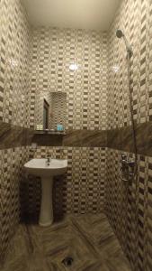 a bathroom with a sink and a shower at Guesthouse Mabu - 4 Newly Built Rooms in the Heart of Mestia in Mestia