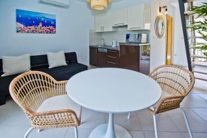 a living room with a white table and chairs at Luxurious Apartments Maslina with Beach in Milna