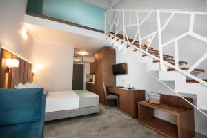 a hotel room with a bed and a staircase at 4- you Family in Metamorfosi