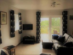 a living room with a couch and a window at Sunnyview Annexe in Saint Briavels