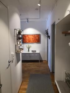 a hallway with a room with a desk and a door at Central Tammela 80m2 in Tampere