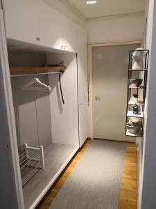 a walk in closet with a door and a rug at Central Tammela 80m2 in Tampere