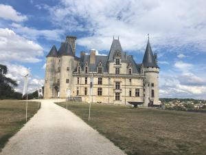 an old castle with a path in front of it at The Two Vines 2 bed house in Chez Ravard in Le-Vieux-Cérier