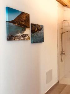 three pictures hanging on a wall in a bathroom at Apartamentos Sunset Lanzarote in Tías