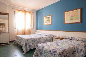 Postel nebo postele na pokoji v ubytování Hotel Clelia