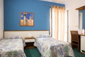 Postel nebo postele na pokoji v ubytování Hotel Clelia