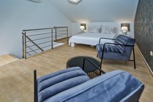 a bedroom with a bed and a chair at Luxurious Apartments Maslina with Beach in Milna