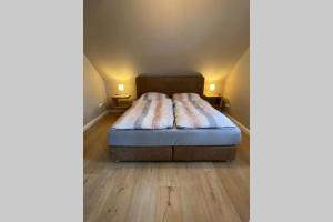 um quarto com uma cama com duas almofadas em Ferienwohnung Zwischen Eider u. Elbe em Eddelak