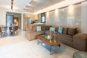 a living room with a couch and a table at 3 DOORS VILLAS in Iraklitsa