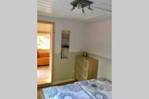 a bedroom with a bed and a dresser and a window at Ferienhaus Green Garden Berlin - Welcome to Berlin in Berlin