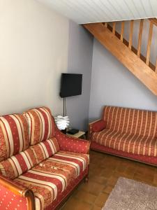 a living room with a couch and a chair at Saint Vincent in Bué