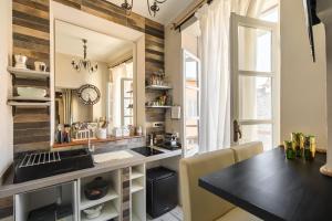 a kitchen with a black counter and a table at Opera Suites - Le mille e una notte in Calcata