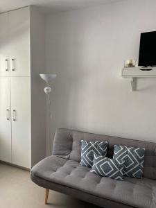 a living room with a couch with pillows on it at Summer Vibes in Achlia