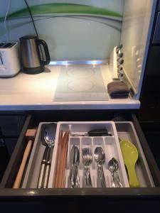 a drawer in a kitchen with utensils in it at Luxury Panoramic Seaside Apartment in Burgas