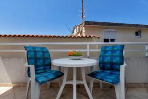 two chairs and a table on a balcony at Residence Apartments in Makarska
