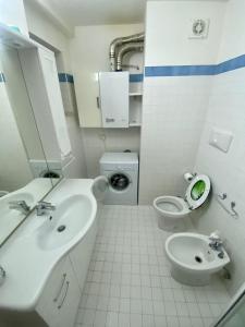 a white bathroom with a sink and a toilet at Residence Cavallino Bianco in Terminillo