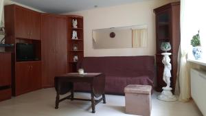 a living room with a couch and a table at Švyturio apartamentai in Klaipėda