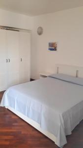 a white bedroom with a large white bed at MAX and SUN parking privato nel prezzo in Sanremo