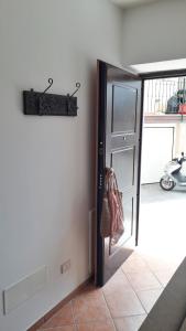 a room with a door with a purse hanging on it at MAX and SUN parking privato nel prezzo in Sanremo